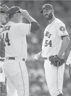  ?? Elizabeth Conley / Houston Chronicle ?? Astros starter Mike Fiers, right, is pulled by manager A.J. Hinch after handcuffin­g the Red Sox over 51⁄ innings Saturday to pick up the win. 3