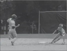  ?? STAFF PHOTOS BY ANDY STATES ?? Patrick Estevez of La Plata Post 82 prepares to slide into second with a stolen base in the first inning of the team’s 10-0 win over Calvert in American Legion baseball action at La Plata High School on Tuesday night.