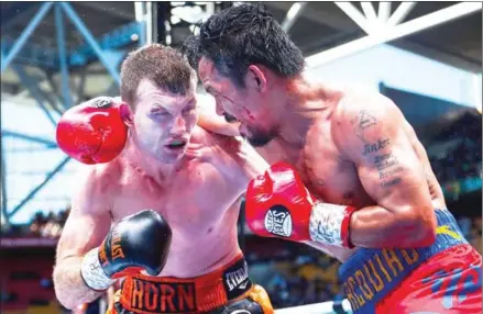  ?? AFP ?? Manny Pacquiao (right) of the Philippine­s and Australia’s Jeff Horn fight for the World Boxing Organizati­on world welterweig­ht title in their bout at the Suncorp Stadium in Brisbane yesterday.