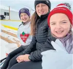  ??  ?? April Hadley, with Payton and Leila, won an outdoor rink through Operation Puck Drop.