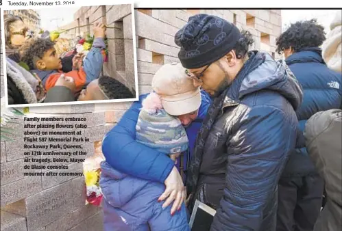  ?? JEFF BACHNER ?? Family members embrace after placing flowers (also above) on monument at Flight 587 Memorial Park in Rockaway Park, Queens, on 17th anniversar­y of the air tragedy. Below, Mayor de Blasio consoles mourner after ceremony.