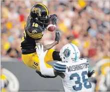  ?? CANADIAN PRESS FILE PHOTO ?? Brandon Banks goes up for the ball and comes down with a touchdown against Toronto during last year’s Classic.