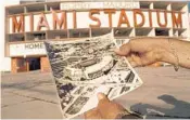  ?? HANS DERYK/AP ?? Ralph Fonseca shows a promotiona­l circa 1950s black and white aerial photograph of Miami Stadium in it’s heyday from his scrapbook as he stands in front of the stadium where it sits in its present broken-down state Tuesday, Feb. 19, 1997.