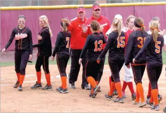  ?? MARK HUMPHREY ENTERPRISE-LEADER ?? Farmington softball coaches Randy Osnes and Steve Morgan exchange greetings with Waldron players after a 4A North Regional game on May 6. Farmington defeated Waldron 6-3 but lost to Booneville 7-3 and Mena 8-7 to place fourth in the tournament they...