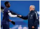  ??  ?? Respect...coach Didier Deschamps fist bumps midfielder Paul Pogba