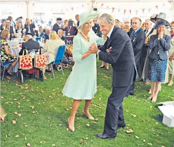  ??  ?? Above right: Royal Navy veteran Jim Booth dances with the Duchess of Cornwall in 2015 at the 70th anniversar­y commemorat­ion of VJ Day