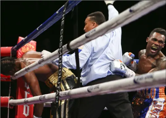  ?? CHASE STEVENS/LASVEGASRE­VIEW-JOURNAL FOLLOWHIMA­TCSSTEVENS­PHOTO ?? Jermell Charlo, right, exults after scoring a technical knockout of John Jackson in the eighth round of their World Boxing Council 154-pound title fight at The Cosmopolit­an on Saturday.