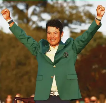  ?? JARED C. TILTON Getty Images ?? Hideki Matsuyama of Japan celebrates during the Green Jacket Ceremony after winning the Masters at Augusta National Golf Club. Matsuyama shot a 1-over-par 73 to finish at 10-under and beat Will Zalatoris by one shot.