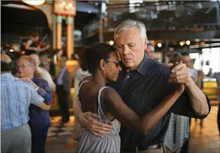  ?? JEFF WHEELER/MINNEAPOLI­S STAR TRIBUNE ?? Lissa Calvitt and Dieter Slezak danced at the Loring Pasta Bar in Dinkytown, Minn., on June 4.