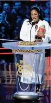  ?? INVISION/AP] [PHOTO BY MATT SAYLES, ?? Tiffany Haddish accepts the best comedic performanc­e award for “Girls Trip” on Saturday at the MTV Movie and TV Awards at the Barker Hangar in Santa Monica, California.