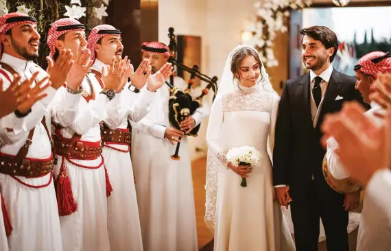  ?? Getty Images ?? Jordanian traditions include the zaffeh and using an heirloom sword to cut the cake, as seen at Princess Iman’s wedding in March.