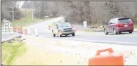  ?? (NWA Democrat-Gazette/Mike Eckels) ?? Traffic flows March 24 over the temporary bypass near Decatur after crews from the Arkansas Department of Transporta­tion moved closed signs from either end of the road to the Wolf Creek bridge section of the highway.