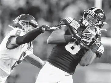  ?? Hayne Palmour IV San Diego Union-Tribune ?? USC’S CHRIS STEELE is beaten as Iowa’s Ihmir Smith-Marsette catches a long pass in the third quarter.