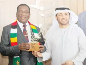 ?? ?? President Mnangagwa poses with global trade and logistics management services agency, DP World, chief executive Mr Abdulla Bin Damithan after a tour of the company premises in Dubai yesterday. (More pictures on Page 2)