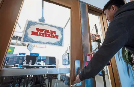  ?? — Bloomberg ?? On the front line: An employee entering the ‘ War Room’ ahead of Brazil’s runoff election at Facebook headquarte­rs in Menlo Park, California.