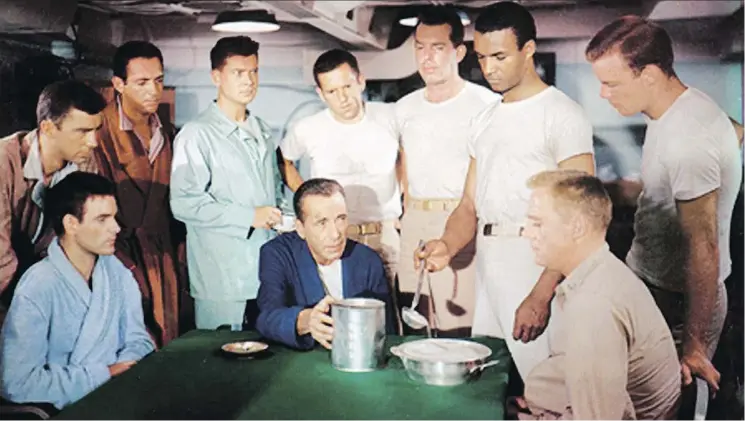  ?? COLUMBIA PICTURES ?? Humphrey Bogart, centre, starred as an unhinged Lt.-Cmdr. Queeg, who confronts his crew over missing strawberri­es in a pivotal scene in 1954’s The Caine Mutiny.