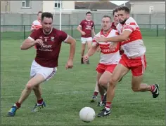  ??  ?? Daithi Waters of St. Martin’s races with Denis Jones (4) and Niall Breen of Kilanerin during the clash Bellefield.