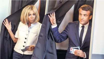  ??  ?? French President Emmanuel Macron and his wife Brigitte Trogneux leave the voting booth at a polling station in Le Touquet