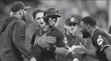  ?? LEAH KLAFCZYNSK­I/TRIBUNE NEWS SERVICE ?? The Cleveland Indians' Francisco Lindor celebrates with teammates after scoring the game-winning run in the 10th inning against the Chicago White Sox on Tuesday in Cleveland.