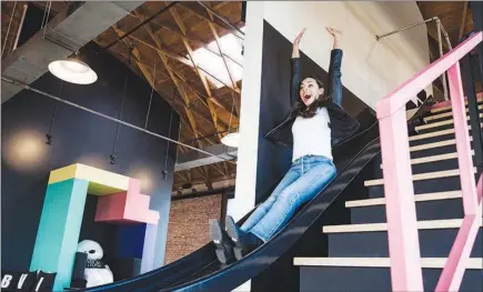  ??  ?? Amber Stevens West rides an office slide at Giphy Studios. Though the GIFS that many use to express an emotion or reaction online are most commonly culled from movies or television, at Giphy Studios, the emphasis is on creating original content.