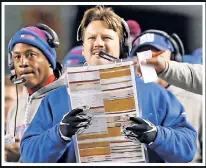  ??  ?? YOU FAKE THE CALL: Twelve-yearold Peter Costigan (right) was brilliant disguising plays as the youngster suited up as Giants coach Ben McAdoo at last week’s game — ordering up some razzle-dazzle from a giant “diner” menu.