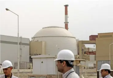  ?? (AFP) ?? This file photo shows technician­s outside the building housing the reactor of the Bushehr nuclear power plant, in Bushehr on February 25, 2009