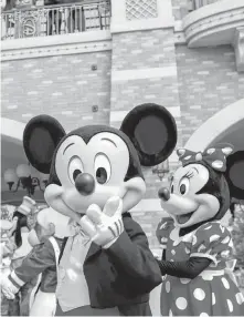  ?? REUTERS ?? Disney characters Mickey Mouse and Minnie Mouse, among others, greet visitors at Shanghai Disney Resort as the Shanghai Disneyland theme park reopens following a shutdown due to the COVID-19 outbreak, in Shanghai, China, Monday.