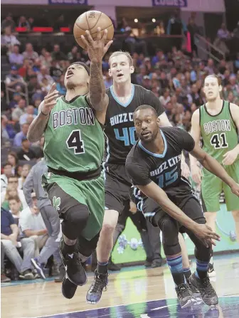  ?? AP PHOTO ?? TASTY SCOOP: Celtics guard Isaiah Thomas drives past the Hornets’ Kemba Walker to put up a shot in the first half of last night’s game in Charlotte, N.C.