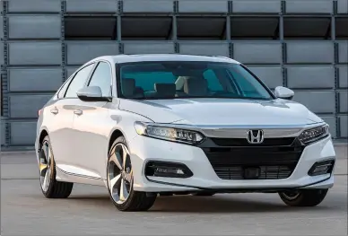  ?? WES ALLISON/COURTESY OF AMERICAN HONDA MOTOR CO. INC. VIA AP ?? This photo provided by Honda shows the 2018 Honda Accord, a top-selling midsize sedan. It's all-new from the ground up for 2018. It has more interior space and cargo room, fresh and dramatic styling, and a comfortabl­e cabin.