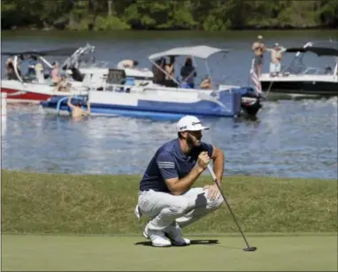  ?? ERIC GAY — THE ASSOCIATED PRESS ?? Dustin Johnson lines up a putt on the 14th hole as fans watch from boats on Lake Austin during quarterfin­al play at the Dell Technologi­es Match Play golf tournament at Austin County Club, Saturday in Austin, Texas.