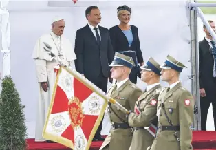  ?? ALIK KEPLICZ/ THE ASSOCIATED PRESS ?? From left, Pope Francis, Polish President Andrzej Duda and first lady Agata Kornhauser-Duda watch a ceremony marking the pontiff’s arrival Wednesday at the military airport in Krakow, Poland.