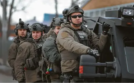  ?? Scott Olson / Getty Images ?? Police secure the area around the Henry Pratt Co. in Aurora, Ill., after a shooting at the manufactur­ing company. Police said they did not know the motive of the gunman, identified as Gary Martin, 45.