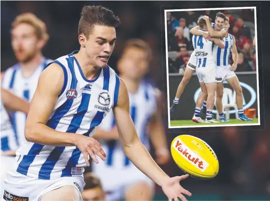  ?? STILL HUNGRY: Josh Williams in action for the Kangaroos last year and ( inset) kicking his first AFL goal on debut. ??