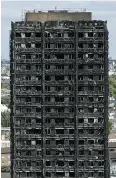  ?? DAN KITWOOD / GETTY IMAGES ?? The management group of the Grenfell Tower housing complex has been told by police it is being investigat­ed in the fire that left 80 people dead.