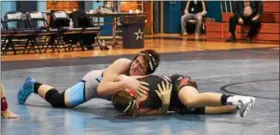  ?? ALEX WAHL — FOR DIGITAL FIRST MEDIA ?? North Penn’s Owen Verespy looks for a pin on William Tennent’s Christian Amato during their 220-pound match Wednesday.