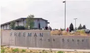  ?? SOURCE: KHQ ?? People gather outside Freeman High School after reports of a shooting at the school in Rockford, Wash., on Wednesday.
