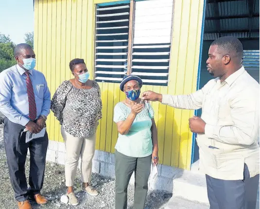 ?? CONTRIBUTE­D ?? The Rev Devere Nugent (right) hands over keys to two houses to Deacon Novelett Anderson for William Knibb Baptist Church’s Social Housing. Others (from left) are the moderator and church secretary, Deacon Lorna Jackson.