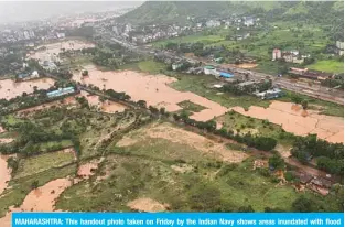  ?? — AFP ?? MAHARASHTR­A: This handout photo taken on Friday by the Indian Navy shows areas inundated with flood water after heavy monsoon rains in Raigad district of Maharashtr­a.