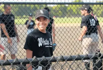  ?? JOHN J. KIM/CHICAGO TRIBUNE ?? Kloey Reyes, 12, smiles while talking with family members before a game at Horner Park on July 27 in Chicago. Kloey is the starting catcher for her White Sox team in the Horner Park North-West Little League.