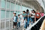  ?? REBECCA BLACKWELL/AP ?? People with visas walk across the Puerta Mexico internatio­nal bridge to enter the U.S. from Matamoros, Mexico.