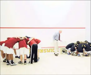  ?? Bob Luckey / Hearst Connecticu­t Media ?? The Taft School squash team, left, and the Brunswick School squash team, right, huddle prior to squash match between Brunswick School and Taft School, at Brunswick School, Greenwich, on Jan. 29, 2011. In the center of the photo is Brunswick School squash coach Jim Stephens.