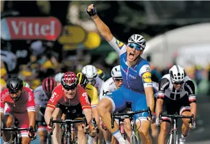  ??  ?? Marcel Kittel, front, celebrates Thursday as he crosses the finish line to win the sixth stage of the Tour de France, a 134-mile course beginning in Vosoul, France, and ending in Troyes, France.