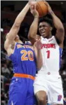  ?? CARLOS OSORIO — THE ASSOCIATED PRESS ?? Detroit’s Stanley Johnson (7) is defended by the Knicks’ Kevin Knox (20) during the second half on Tuesday in Detroit.