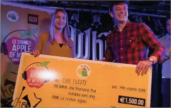  ??  ?? Marie Herrmann from Le Crunch presenting a cheque for €1,500 to Ovens singer/ songwriter Dan Elliot, winner of the 2018 ‘Apple of My Eye’ song contest.