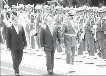  ??  ?? A handout picture released by the official website of the Iranian president shows Pakistan’s Prime Minister Nawaz Sharif (center), and Iran’s First Vice President Eshaq Jahangiri (left), reviewing the honour guard during a welcoming ceremony
at...