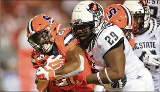  ?? STREETER LECKA / GETTY IMAGES ?? N.C. State’s Alim McNeill (29) hits Syracuse’s Abdul Adams during the Wolfpack’s 16-10 win last Thursday. The Orange fell to 0-2 in the ACC after the loss.