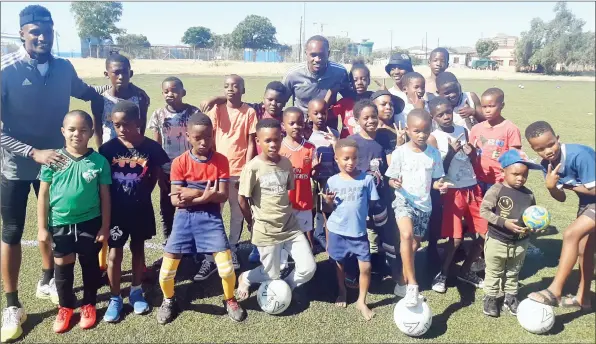  ??  ?? Ploughing back… Namibia’s England-based star defender Ryan Nyambe is seen here with some of the participan­ts.