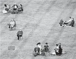  ?? CHARLIE RIEDEL/AP ?? A socially distanced crowd listens to the Kansas City Symphony on Sept. 19 in Missouri.