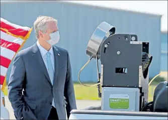  ?? STUART CAHILL / BOSTON HERALD ?? Gov. Charlie Baker checks out a pesticide sprayer prior to speeking to the media at the Plymouth County Mosquito Control Project on July 7 in Plymouth. The House, 158-0, and the Senate, on a voice vote without a roll call, approved a law that would grant additional tools to the State Reclamatio­n and Mosquito Control Board to combat mosquito-borne illnesses including Eastern Equine Encephalit­is and West Nile Virus.