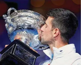  ?? Clive Brunskill/Getty Images ?? Novak Djokovic kisses the Norman Brookes Challenge Cup after winning the Men’s Singles Final match against Stefanos Tsitsipas at the Australian Open on Sunday in Melbourne, Australia.